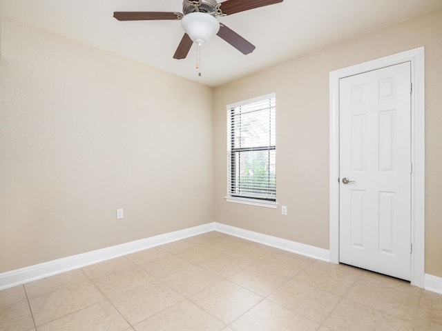 unfurnished room with ceiling fan and light tile patterned floors