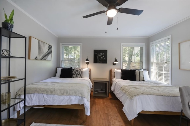 bedroom with crown molding, hardwood / wood-style flooring, and ceiling fan