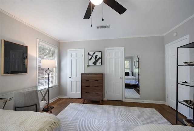 bedroom featuring dark wood-type flooring, ceiling fan, and crown molding