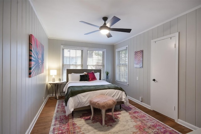 bedroom with crown molding, ceiling fan, and hardwood / wood-style floors