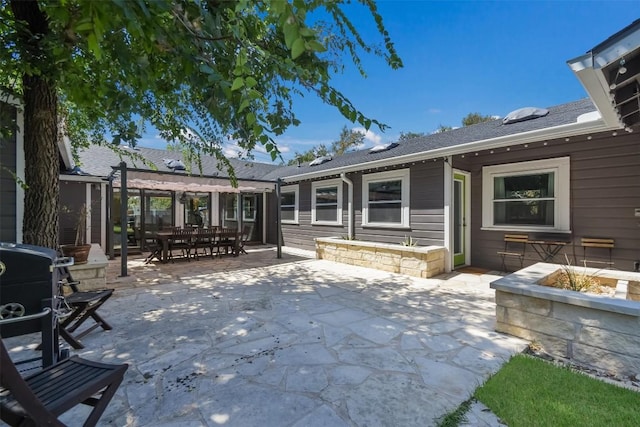 view of patio / terrace featuring grilling area, an outdoor fire pit, and a pergola