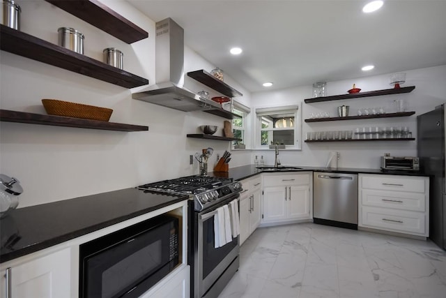 kitchen featuring island exhaust hood, appliances with stainless steel finishes, sink, and white cabinets