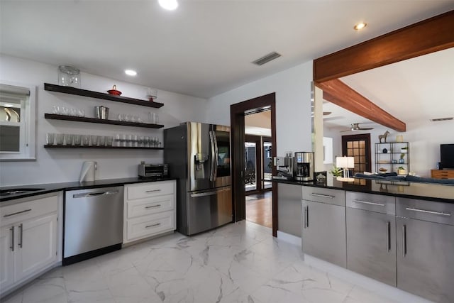 kitchen with white cabinetry, beam ceiling, ceiling fan, and appliances with stainless steel finishes