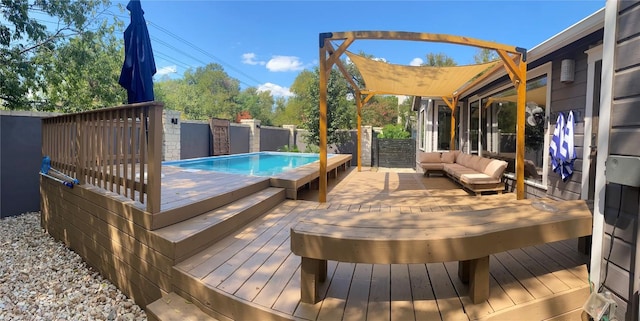 wooden deck with a fenced in pool and an outdoor living space