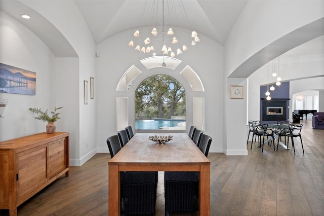 dining room with lofted ceiling, hardwood / wood-style floors, and a chandelier