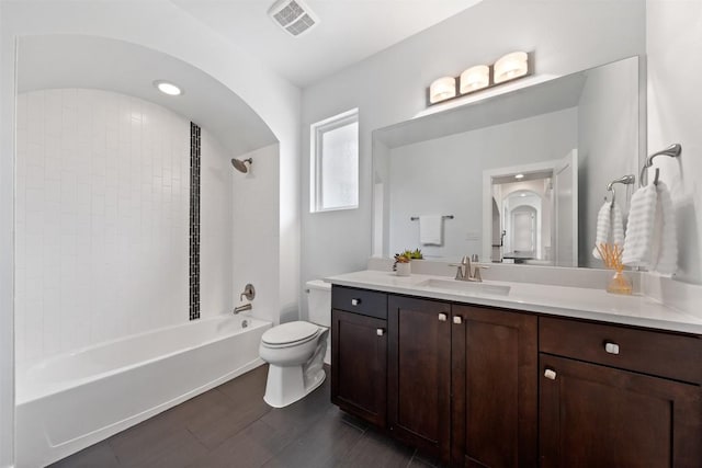 full bathroom featuring tiled shower / bath, vanity, toilet, and wood-type flooring