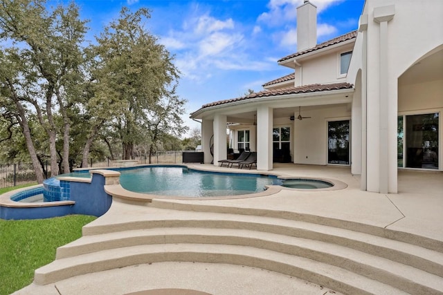 view of swimming pool featuring an in ground hot tub, ceiling fan, and a patio area