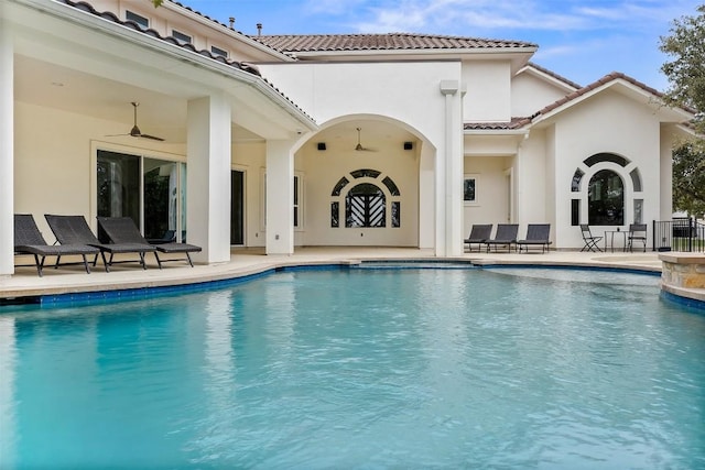 view of swimming pool featuring a patio and ceiling fan