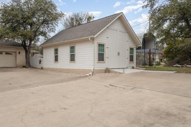 view of front of house featuring a garage and a carport