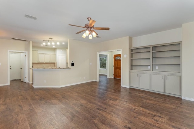 unfurnished living room featuring dark wood-style floors, ceiling fan, visible vents, and baseboards