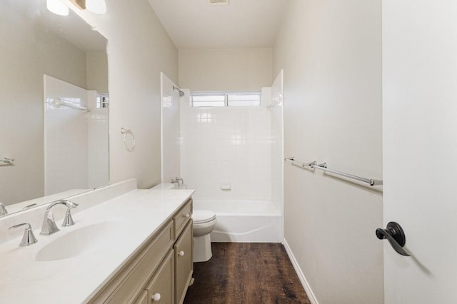 bathroom with shower / bathtub combination, toilet, vanity, wood finished floors, and baseboards