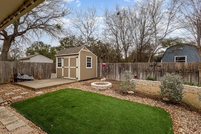 view of yard featuring an outbuilding, a storage unit, and a fenced backyard