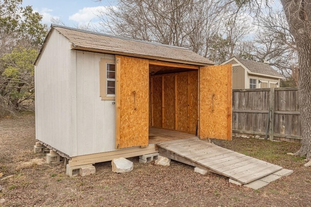 view of shed with fence