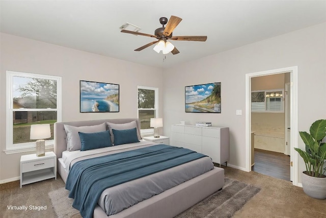 bedroom featuring carpet floors, baseboards, visible vents, and ensuite bathroom