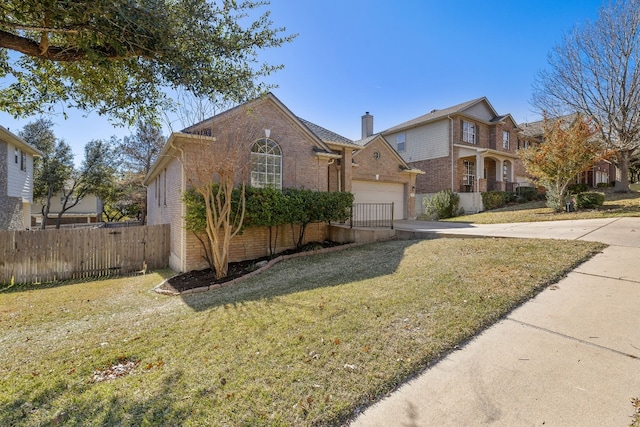 view of property featuring a garage and a front lawn