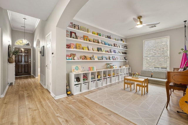 playroom featuring ornamental molding, hardwood / wood-style floors, and ceiling fan