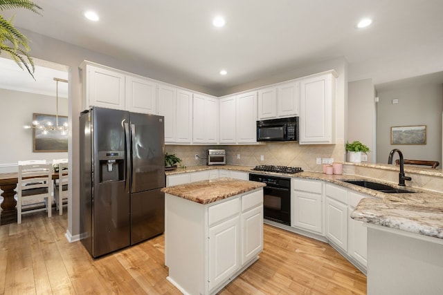 kitchen with black appliances, white cabinetry, sink, light hardwood / wood-style floors, and light stone counters