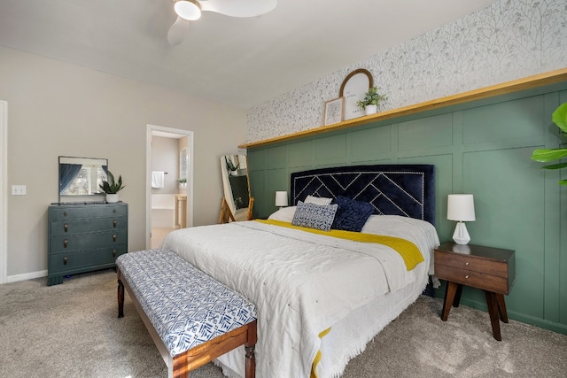 bedroom with ensuite bath, carpet floors, and ceiling fan