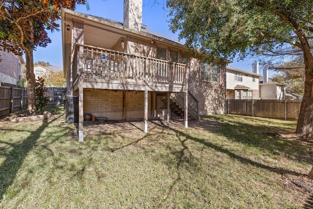 back of property with a wooden deck and a yard