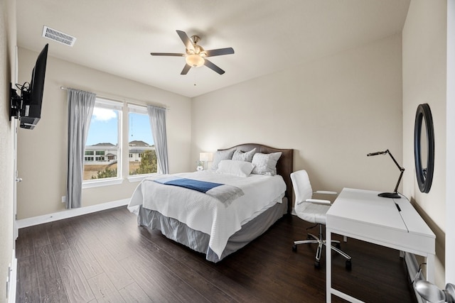 bedroom featuring dark wood-style floors, baseboards, visible vents, and ceiling fan