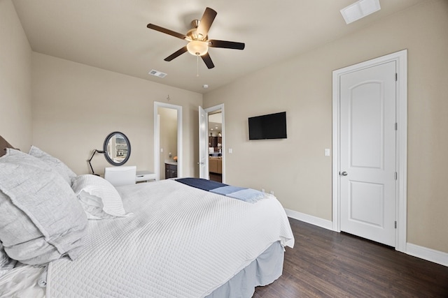 bedroom with wood finished floors, visible vents, and baseboards