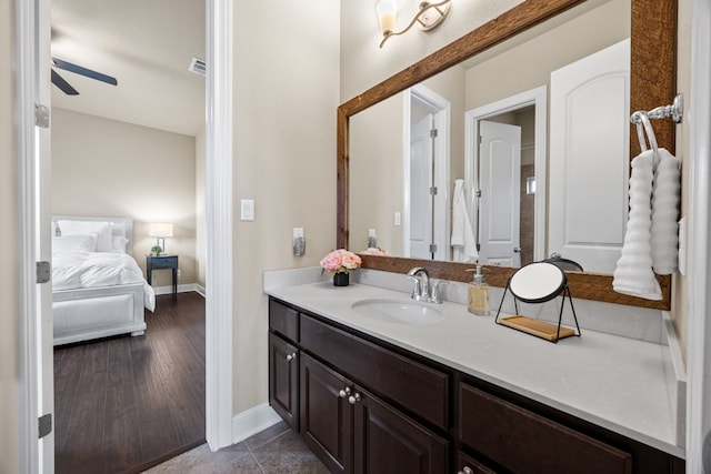 bathroom featuring a ceiling fan, visible vents, vanity, and baseboards