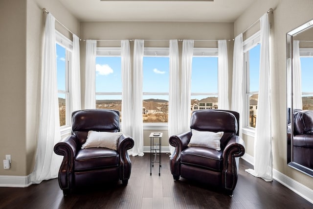 sitting room featuring baseboards and dark wood finished floors