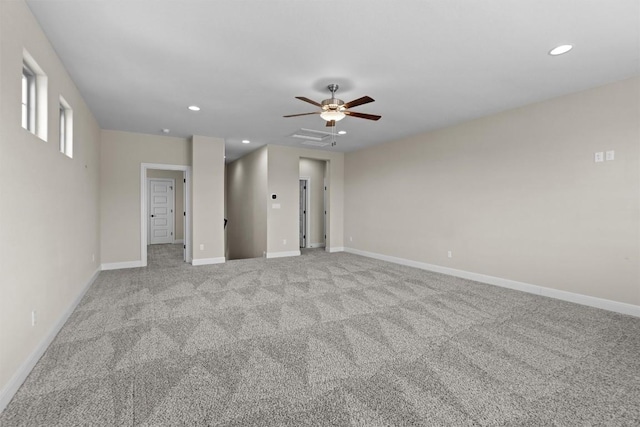 empty room with ceiling fan and light carpet