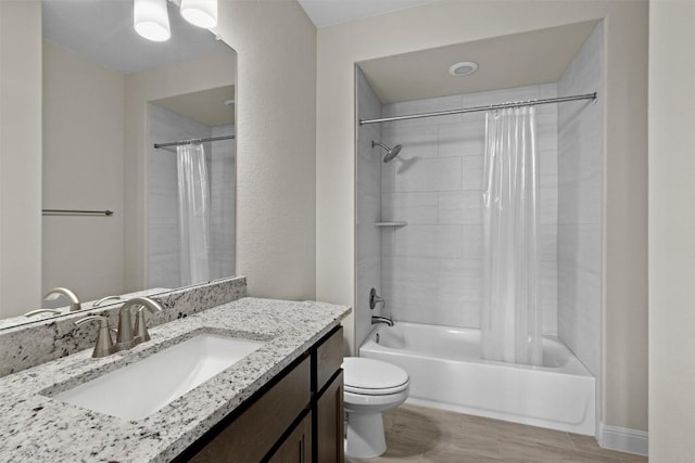 full bathroom with vanity, toilet, hardwood / wood-style floors, and shower / bath combo with shower curtain