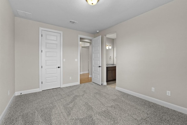 305 Miranda Way, Georgetown, TX 78633 - unfurnished bedroom featuring light carpet, baseboards, and ensuite bath