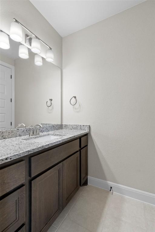 305 Miranda Way, Georgetown, TX 78633 - bathroom featuring vanity, baseboards, and tile patterned floors