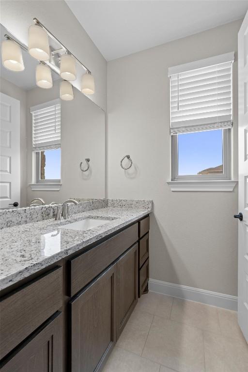 bathroom with tile patterned flooring, vanity, and plenty of natural light