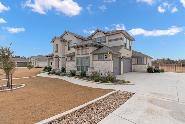 305 Miranda Way, Georgetown, TX 78633 - view of front facade featuring stone siding, concrete driveway, stucco siding, an attached garage, and a shingled roof
