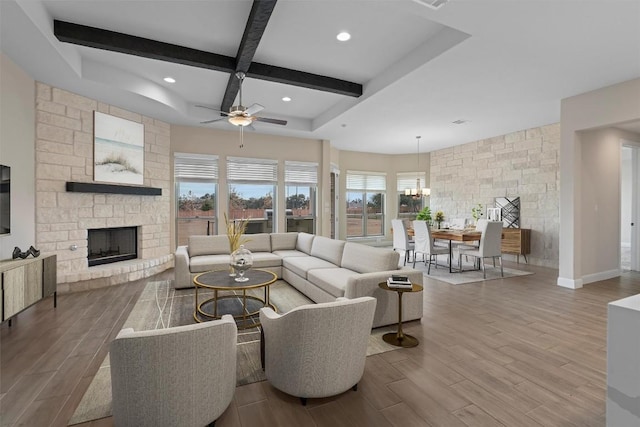 305 Miranda Way, Georgetown, TX 78633 - living area with ceiling fan, wood finished floors, beam ceiling, a stone fireplace, and coffered ceiling