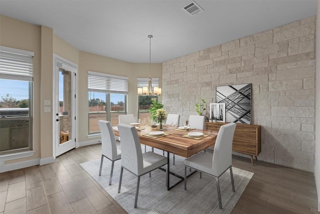 dining room featuring hardwood / wood-style flooring and a chandelier