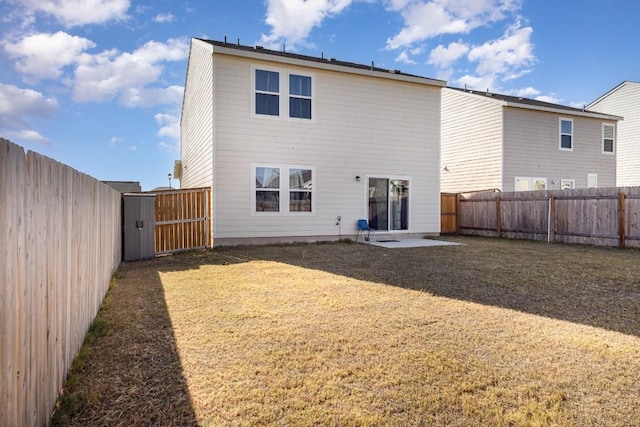 rear view of house featuring a yard