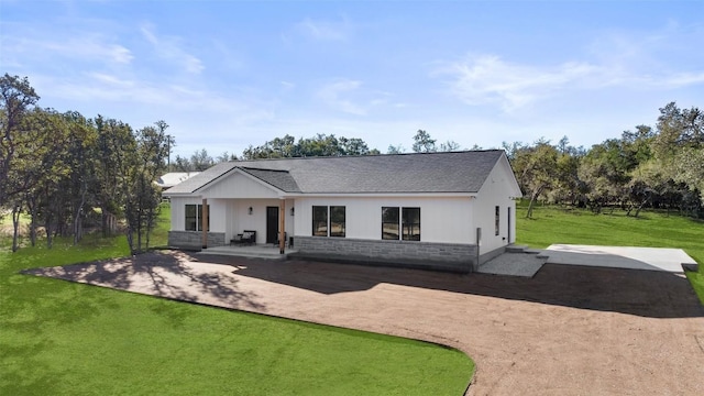 view of front facade with a patio and a front lawn