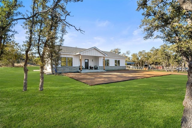 rear view of house featuring a lawn