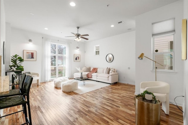 living room featuring ceiling fan and light hardwood / wood-style floors