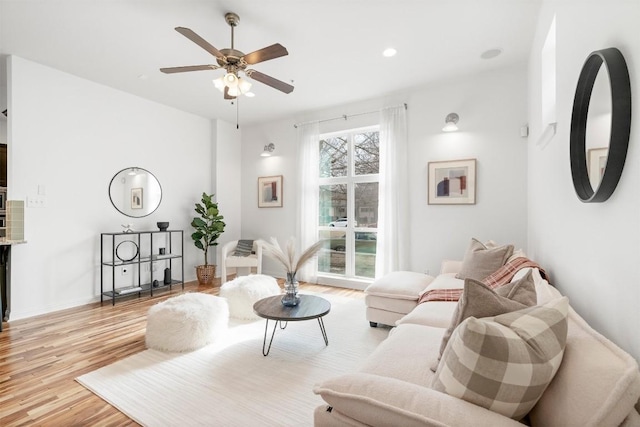 living room with ceiling fan and light wood-type flooring