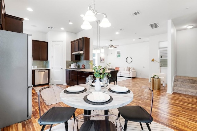 dining room featuring ceiling fan and light hardwood / wood-style flooring