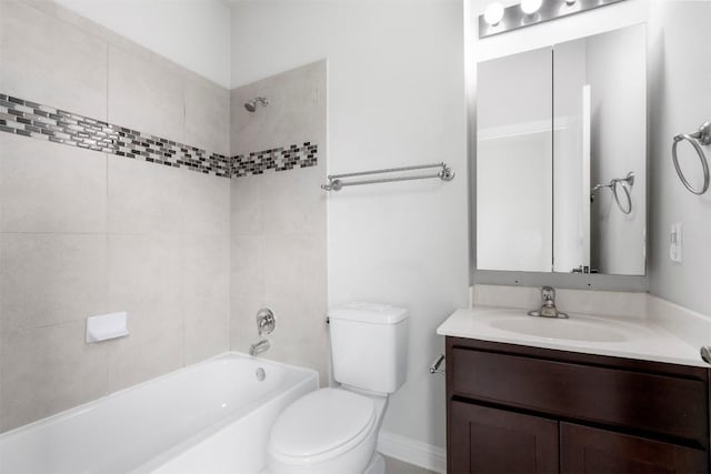 full bathroom featuring tiled shower / bath, vanity, and toilet