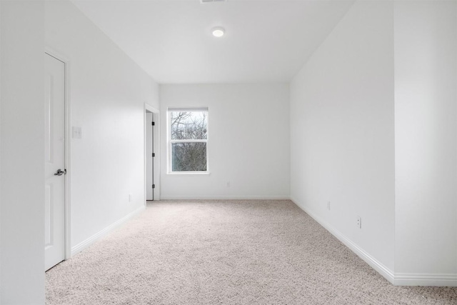 unfurnished room with light colored carpet