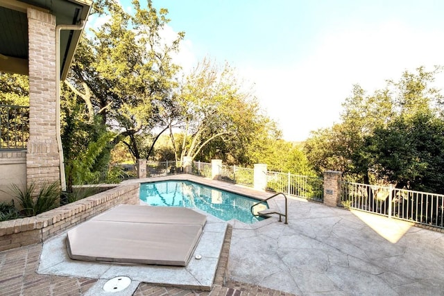 view of pool with a fenced in pool, a fenced backyard, and a patio