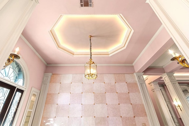 details featuring crown molding, an inviting chandelier, a tray ceiling, and decorative columns