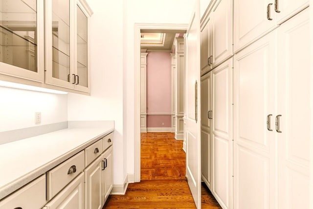 corridor featuring dark hardwood / wood-style floors and a raised ceiling