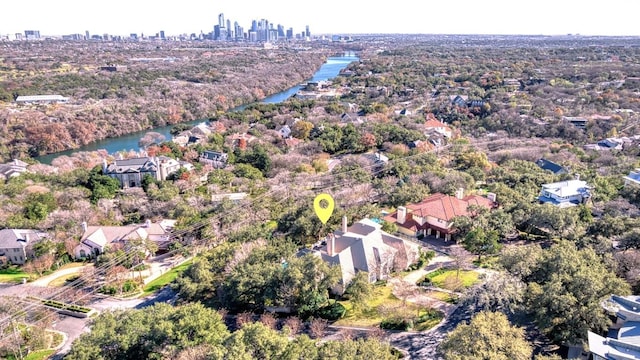 aerial view of property and surrounding area featuring a large body of water and city skyline