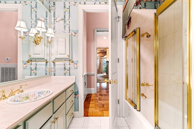 bathroom featuring wallpapered walls, visible vents, bath / shower combo with glass door, tile patterned floors, and vanity