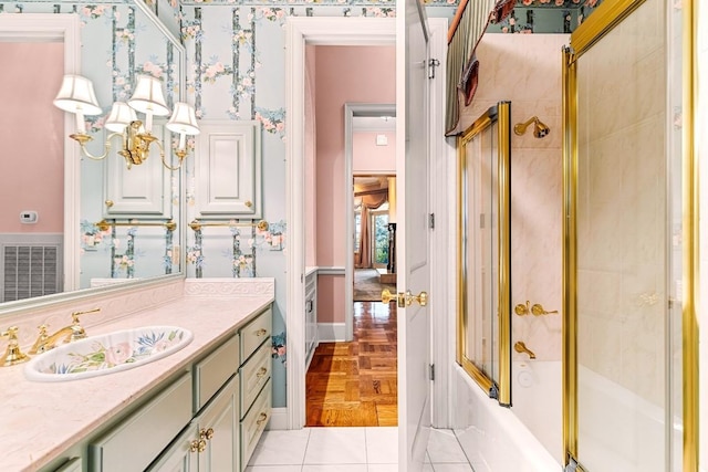 full bath with wallpapered walls, vanity, shower / bath combination with glass door, and tile patterned floors