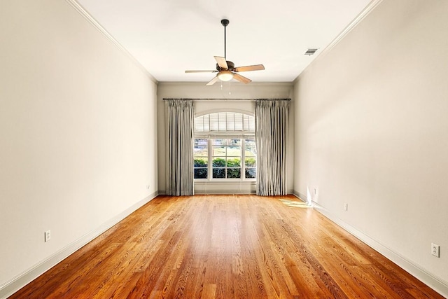 spare room with ceiling fan, ornamental molding, and light wood-type flooring